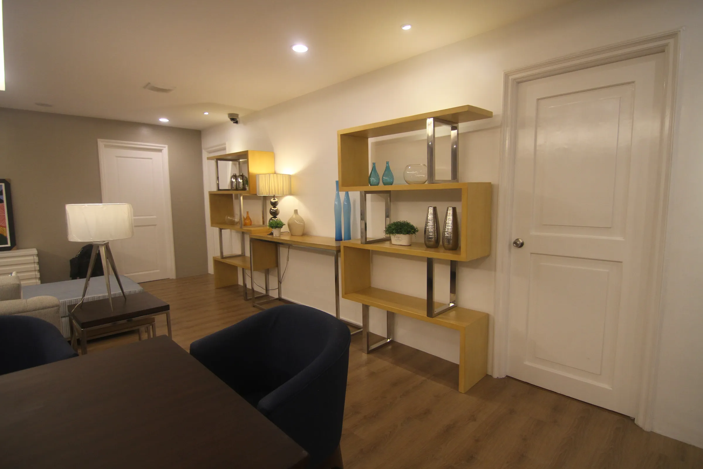 Console table and display shelving in a suite entryway.